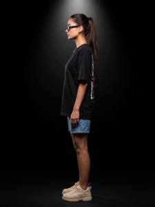 "Sevenfold oversized tshirt female side profile full body studio black background"