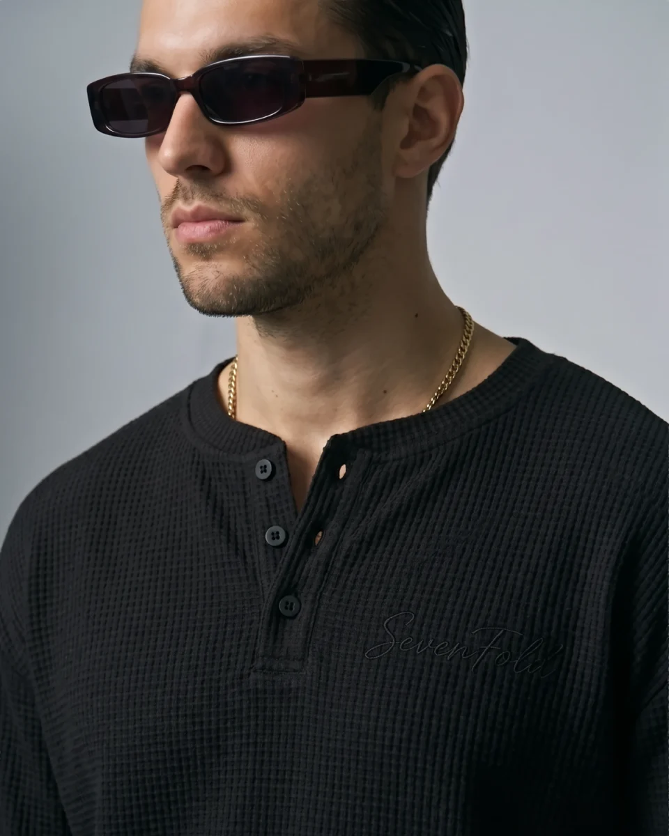 Close-up embroidery and waffle texture detail of black SEVENFOLD Signature Henley