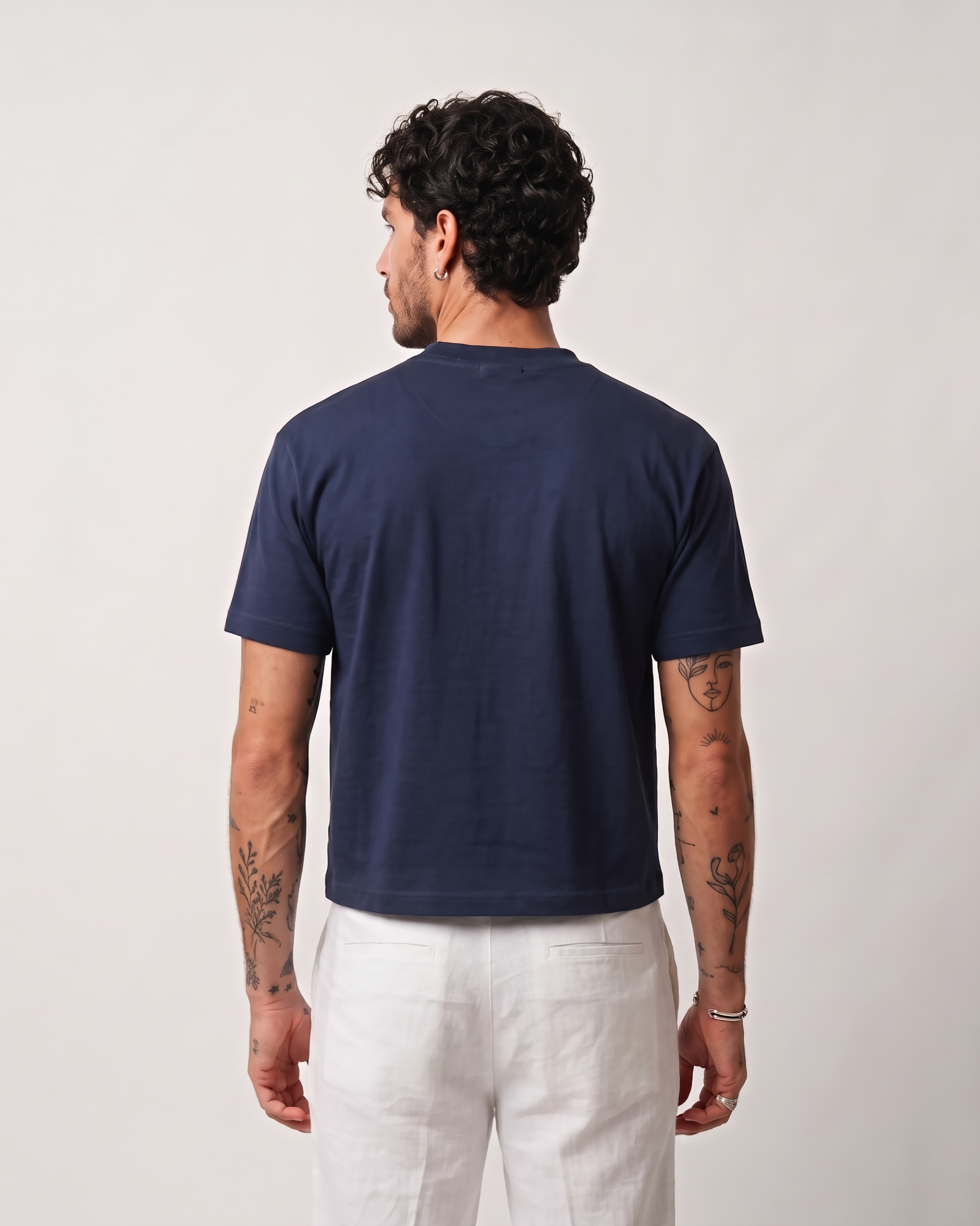 Back view of a model wearing a navy blue boxy fit T-shirt