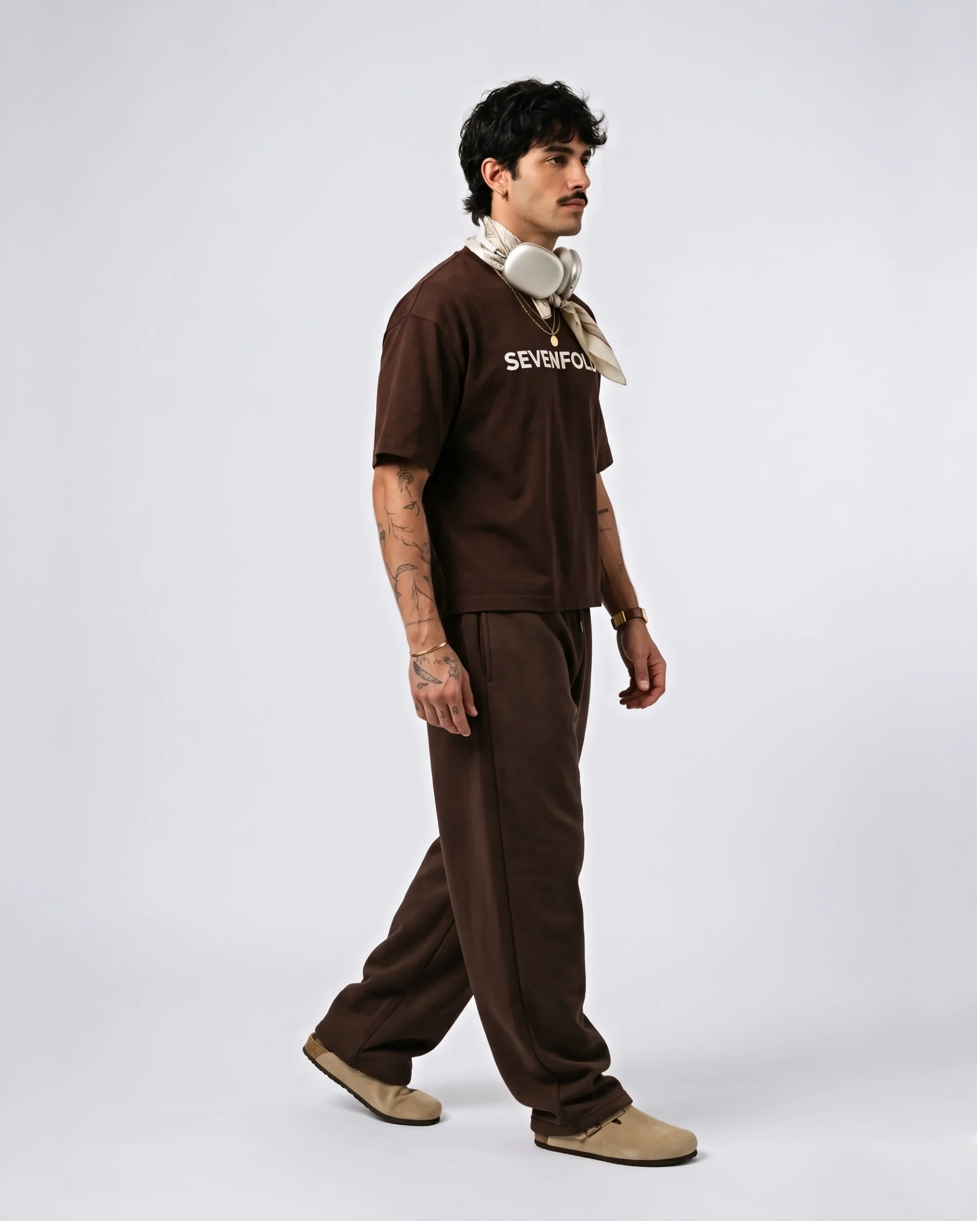 Side view of model wearing brown Rome graphic oversized T-shirt