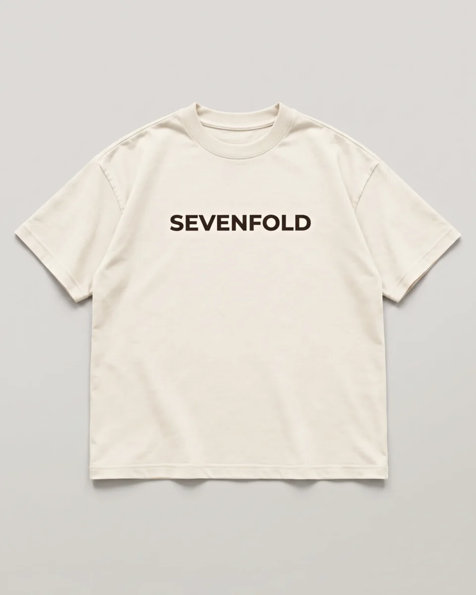 Front product image of an ivory SEVENFOLD T-shirt with a centered dark logo