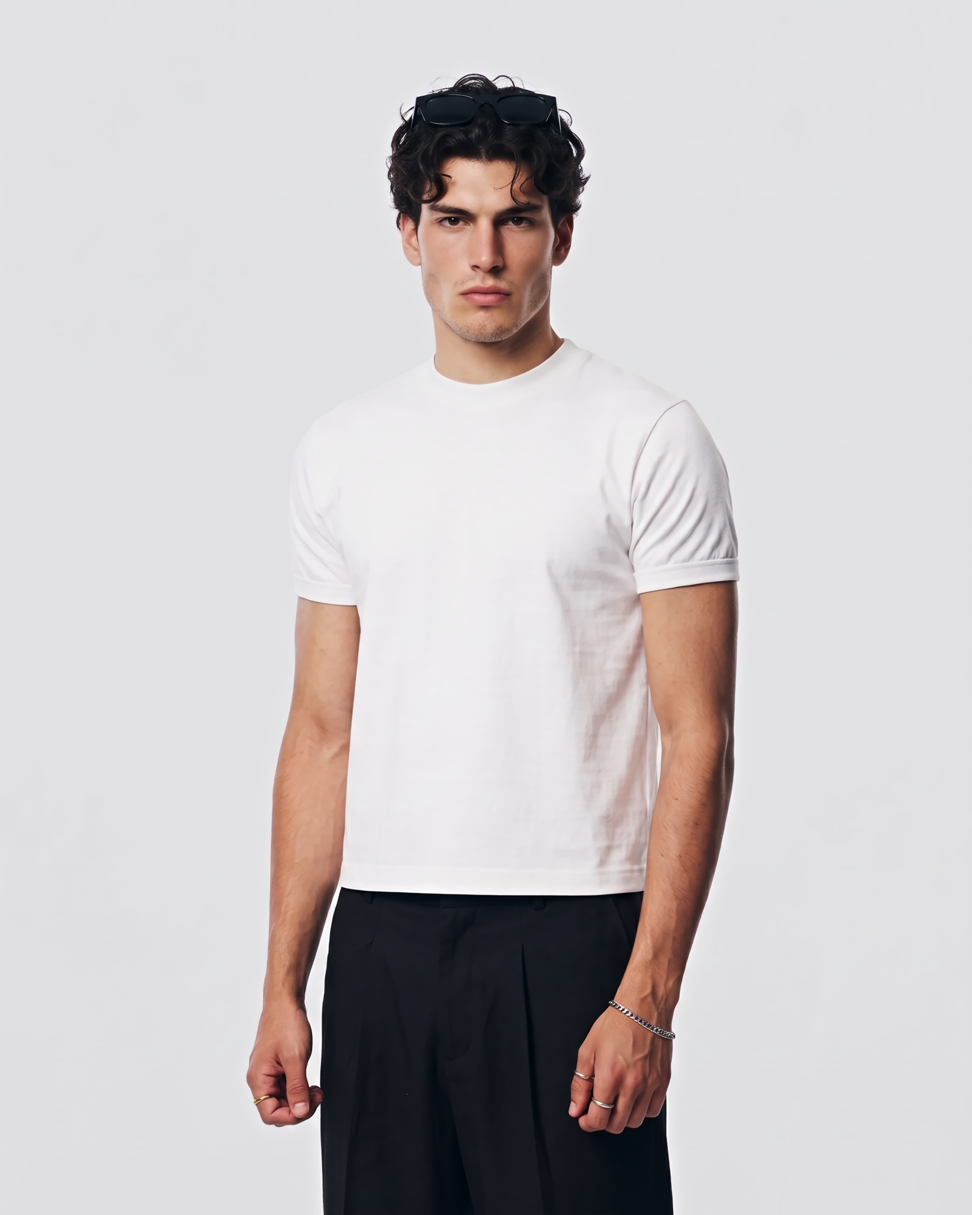Three-quarter view of a model wearing the SEVENFOLD white muscle fit boxy cropped T-shirt